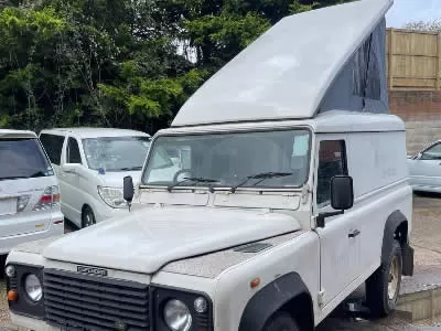 White landrover defender with camper conversion